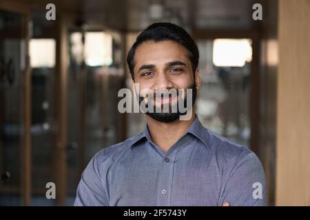 Portrait of young happy indian business man executive looking at camera. Stock Photo