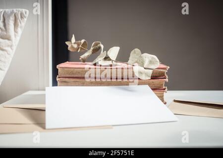 blank greeting card  invitation mockup with craft paper envelope  feminine still life composition Stock Photo