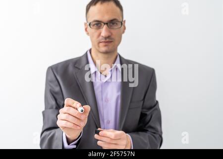male writing something on glass board with marker Stock Photo