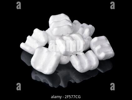 Group of m-shaped styrofoam packing chips isolated on black Stock Photo