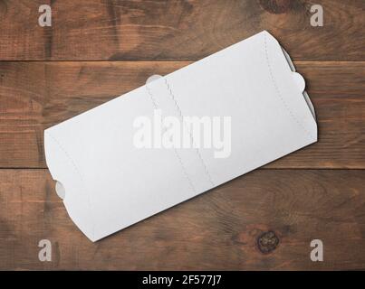 Top view of white blank new folded donner kebab paper packaging on wooden background Stock Photo