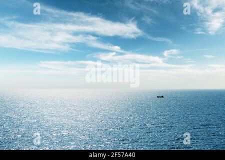 Lonely fishing ship trawler boat on ocean Stock Photo