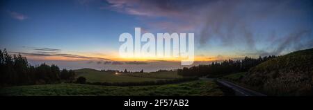 Panorama during sunset at Sao Miguel island, Azores travel destination, view over pastures and the Atlantic ocean. Stock Photo
