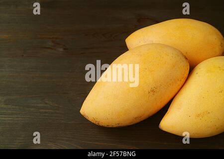 Pair of Fresh Ripe Mango Fruits Isolated on Black Wooden Background Stock Photo