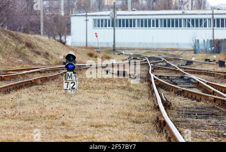 Railway control traffic light, semaphore. Railroad transport and signal lights at the fork of the old railway on a spring day. Stock Photo
