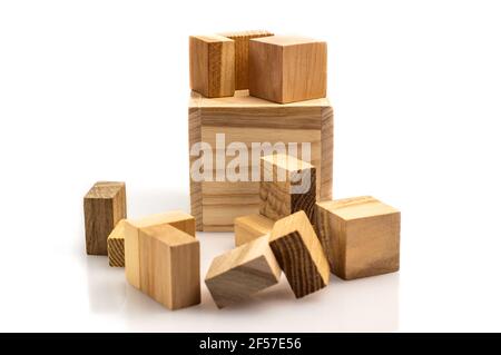 Wooden brain cube. Wooden puzzle made up of parts isolated on a white background. Business success concept. Layout for presentation. Stock Photo