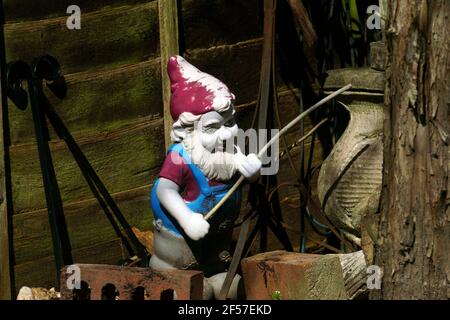 GNOME FISHING IN THE GARDEN Stock Photo