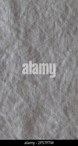 Top view on gray crumpled linen fabric background. Close-up of tea towel, napkin, tablecloth or clothing. Concept of simplicity, environmental friendl Stock Photo