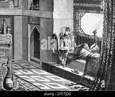 A Tartar man sitting in parlor smoking a waterpipe, Asia, Caucasus Mountains, wood engraving, Wien. Leipzig 1881 Stock Photo