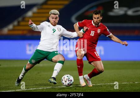Republic of Ireland's Aaron Connolly (left) and Serbia's Milan Gajic battle for the ball during the 2022 FIFA World Cup Qualifying match at the Rajko Mitic Stadium in Belgrade, Serbia. Picture date: Wednesday March 24, 2021. Stock Photo