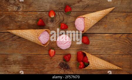 Strawberry ice cream in a waffle cone. Red berries and ice cream balls Stock Photo