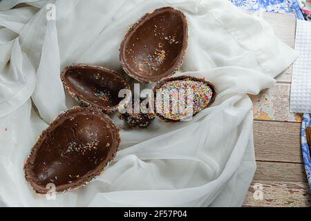 Several half of easter eggs inside each other. Covered with colorful chocolate sprinkles (Pinata Easter egg). Stock Photo