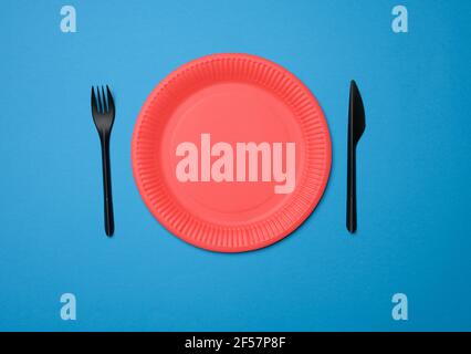 empty red paper disposable plates on a blue background, top view Stock Photo