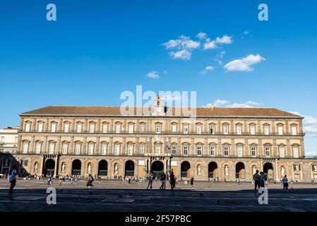 Naples, Italy - September 9, 2019: Facade of the Royal Palace of Naples (Palazzo Reale di Napoli) in Piazza del Plebiscito with people around, Italy Stock Photo