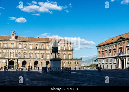 Naples, Italy - September 9, 2019: Facade of the Royal Palace of Naples (Palazzo Reale di Napoli) and the monument to Charles VII of Naples in Piazza Stock Photo