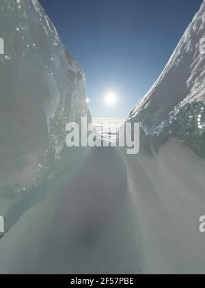 Ice slopes in sunny winter day, transparent ice of blue color, purely blue sky, long shadows, a pure snow-covered virgin soil, snow barkhans,  Stock Photo