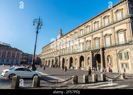 Naples, Italy - September 9, 2019: Facade of the Royal Palace of Naples (Palazzo Reale di Napoli) in Piazza del Plebiscito with people around, Italy Stock Photo