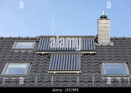 solar thermal panels on the roof of a residential building Stock Photo