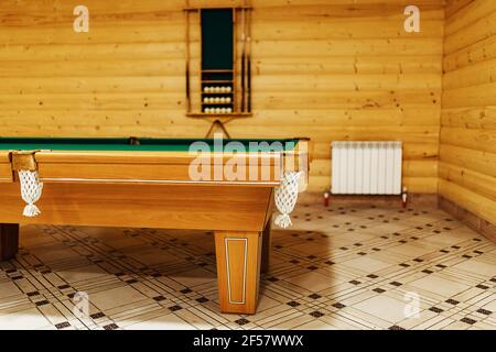 pool table in the sauna. recreation and sports entertainment sports entertainment during your vacation. wooden table with green cloth in a private hou Stock Photo
