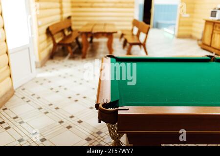 pool table in the sauna. recreation and sports entertainment sports entertainment during your vacation. wooden table with green cloth in a private hou Stock Photo