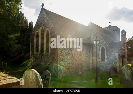 Wide-shot of St Martin Church at Canterbury with the sun flaring in the background Stock Photo