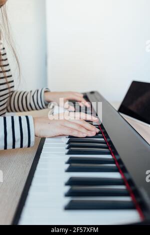 Hands of a young girl playing the piano Stock Photo