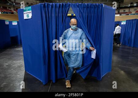 (210324) -- PARIS, March 24, 2021 (Xinhua) -- A medical worker walks out a box of a COVID-19 vaccination center at the National Velodrome de Saint-Quentin-en-Yvelines in Saint-Quentin-en-Yvelines, France, on March 24, 2021. French President Emmanuel Macron on Tuesday stressed the importance of vaccination as the country's COVID-19 cases kept rising. Since the start of the vaccination campaign in France, nearly 6.6 million people, or about 12.6 percent of the adult population, have received at least one injection, and over 2.5 million have received two injections, according to the Health Minist Stock Photo