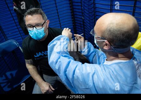 (210324) -- PARIS, March 24, 2021 (Xinhua) -- A man receives the COVID-19 vaccine in a COVID-19 vaccination center at the National Velodrome de Saint-Quentin-en-Yvelines in Saint-Quentin-en-Yvelines, France, on March 24, 2021. French President Emmanuel Macron on Tuesday stressed the importance of vaccination as the country's COVID-19 cases kept rising. Since the start of the vaccination campaign in France, nearly 6.6 million people, or about 12.6 percent of the adult population, have received at least one injection, and over 2.5 million have received two injections, according to the Health Min Stock Photo