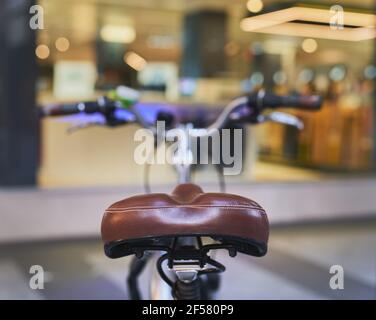 detail of a rear view of a bicycle seat with handlebars out of focus Stock Photo