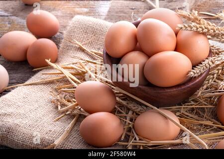 Healthy domestic eggs in a wooden bowl on a rustic table Stock Photo