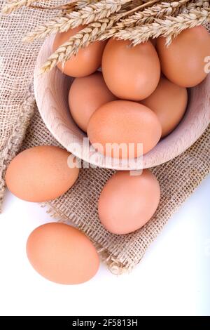 Free range eggs in a wooden bowl on a linen canvas Stock Photo