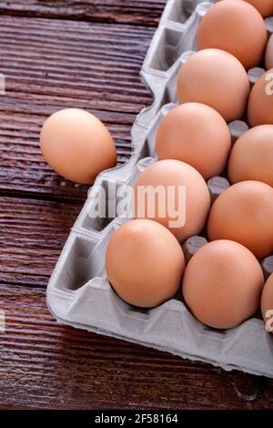 eggs arranged in a cardboard on a wooden table Stock Photo