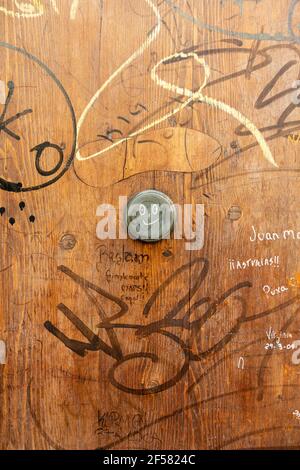 Closeup of a Very Old Wooden Door Covered in Graffiti and Tagged in Florence, Italy Stock Photo