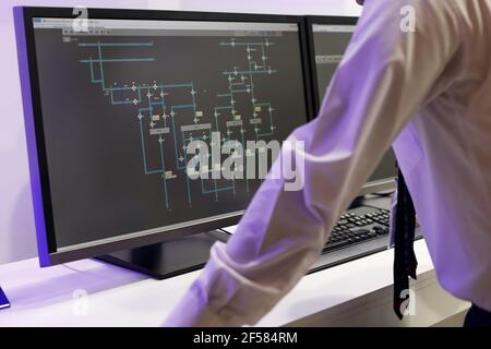 Control room operator regulates the technological processes using computers. Selective focus. Stock Photo