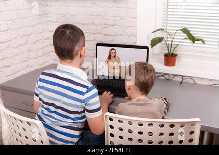 Two happy small friends. Boys using smart digital tablet at home. Stock Photo