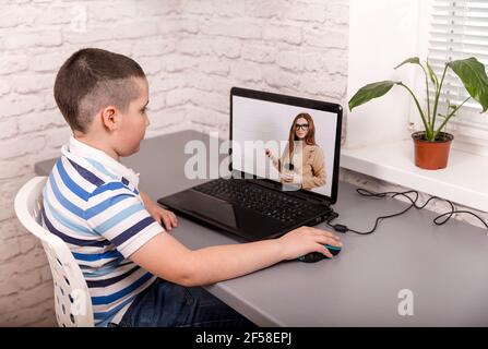 Distance teacher having video conference call with pupil using webcam. Stock Photo