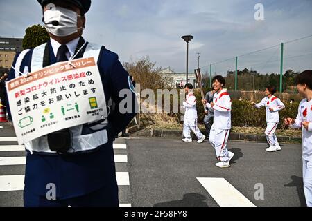 FUKUSHIMA, March 25, 2021  Iwashimizu Azusa (3rd R), a former member of Japan women's national football team, carries an Olympic Torch during the torch relay for Tokyo Olympic Games at J-Village National Training Center in Futaba, Fukushima of Japan, on March 25, 2021. (Philip Fong/Pool via Xinhua) Stock Photo