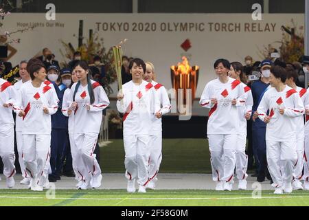 Fukushima, Fukushima of Japan. 25th Mar, 2021. Iwashimizu Azusa (C) and other former members of 'Nadeshiko Japan', the Japan women's National Football Team, run as torchbearers in the first leg of the torch relay for Tokyo Olympic Games at J-Village National Training Center in Futaba, Fukushima of Japan, on March 25, 2021. Credit: Du Xiaoyi/Xinhua/Alamy Live News Stock Photo