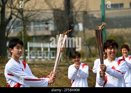FUKUSHIMA, March 25, 2021  Iwashimizu Azusa (R, front), former member of 'Nadeshiko Japan', the Japan women's National Football Team, and Japanese high school student Asato Owada are seen on the first day of the Tokyo 2020 Olympic torch relay in Futaba, Fukushima of Japan, on March 25, 2021. (Philip Fong/POOL via Xinhua) Stock Photo