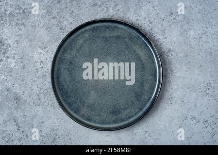 An empty plate on a gray table. Stock Photo