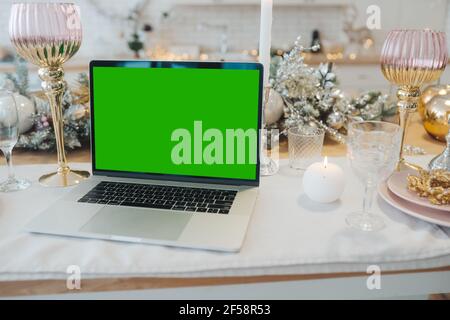 laptop with green screen - chromakey near New Year's decorations. christmas theme. Stock Photo