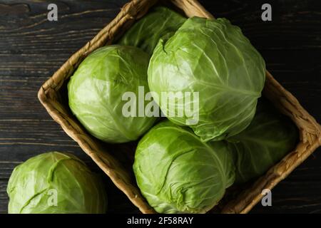 Basket with fresh cabbage on wooden table Stock Photo