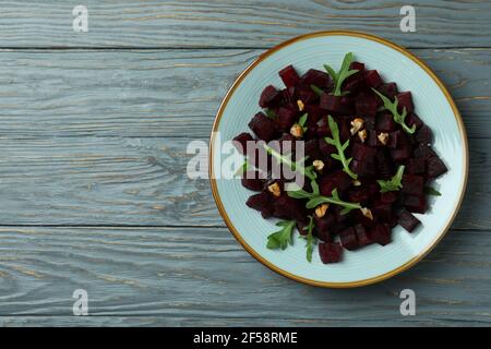 Bowl with fresh beet salad on wooden table Stock Photo