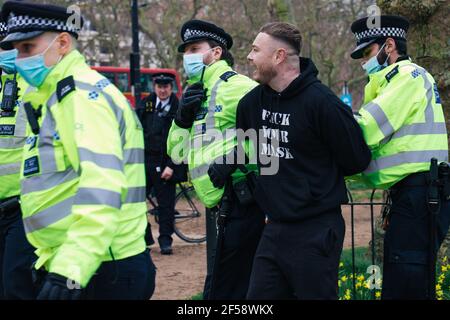 London, UK, 20th March 2021. Around 6000 anti lockdown and anti vaccination protestors and those against the Police, Crime, Sentencing and Courts Bill march in central London. The protest began in Hyde Park with a spate of arrests and an address by Piers Corbyn who is running for London Mayor, marched without trouble through central London and finished with a tense stand off back in Hyde Park between around 200 remaining protestors and riot police.  A man is arrested in Hyde Park ahead of the march through the streets.
