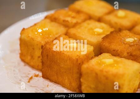 Classic dessert of Hong Kong tea restaurant, condensed milk deep-fried western toast cubes Stock Photo