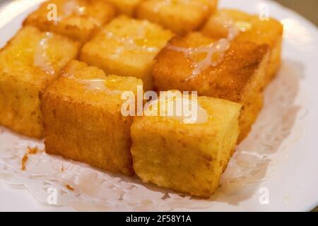 Classic dessert of Hong Kong tea restaurant, condensed milk deep-fried western toast cubes Stock Photo