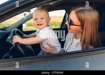 Happy family, mom and her little son, are driving in the car summer vacation, vacation, travel, Stock Photo