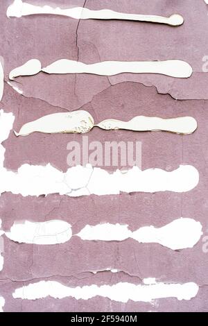 Cracked dried glue frame remains on the old weathered cement pink wall with cracks. Torn up poster, billboard. Abstract background Stock Photo