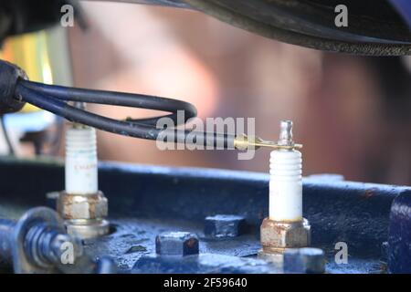 Spark Plug and lead on top of old engine Stock Photo