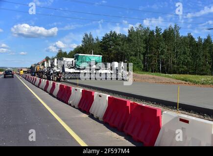 Slip Form Concrete Paver Machine on construction highway. Building machines for road construction applications. Stock Photo